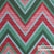 Groen en rood zigzagpatroon van de waterafstotende Acapulco meubelstof geschikt voor buitengebruik.