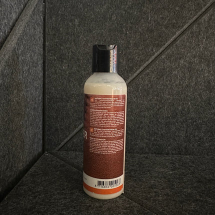 Natural Leather Wax & Oil 150 ml bottle for leather care and conditioning on a dark textured surface