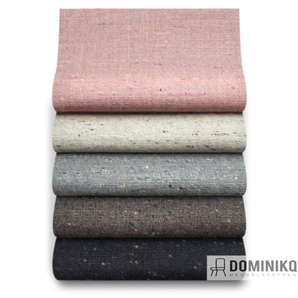 Stapel van Bute Fabrics Alchemy stoffen in diverse kleuren, waaronder roze, beige en grijs, voor veelzijdig meubelgebruik.