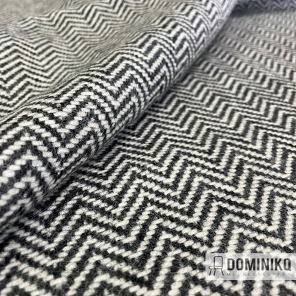 Wollen meubelstof Lewis CF840-0116 Flint van Bute Fabrics met zigzag- en chevronpatroon in zwart en wit, geschikt voor meubels.