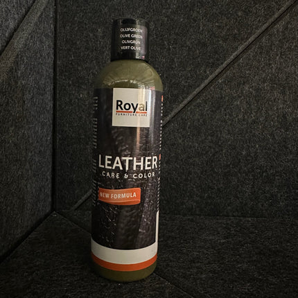 Bottle of Leather Care & Color Lederwas - 250 ml by Royal Furniture on a dark textured background.