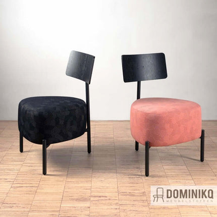 Twee stoelen met Razzle Dazzle stof in zwart en roze op houten vloer. Ideaal voor bredere meubels door complex patroon.