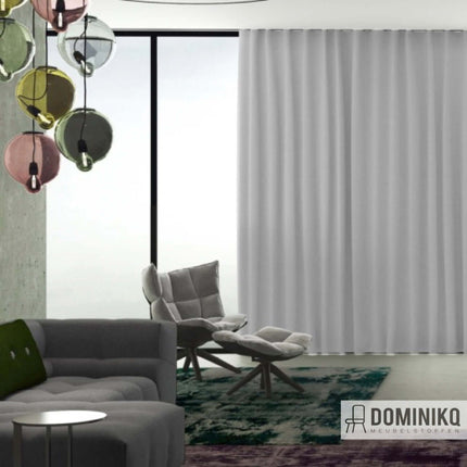 Moderne woonkamer met witte Ritu van Kendix-gordijnen, kleurrijke verlichting en stijlvolle fauteuil, perfect voor natuurlijk lichtinval.