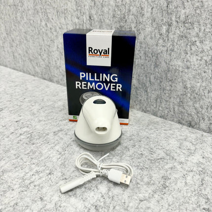 USB-oplaadbare pluizenverwijderaar met verpakking en oplaadkabel