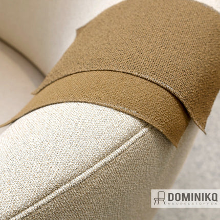 Moderne bouclé-stof Grain in bruin op een meubel, geeft warmte en diepte aan interieur, grotendeels gemaakt van recyclebaar polyester.