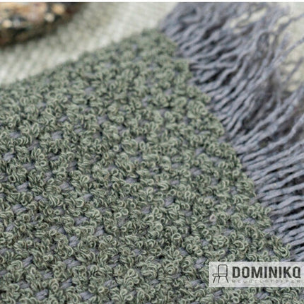 Groene Vescom Foster bouclé meubelstof van gerecycled polyester voor duurzaam interieurdesign.