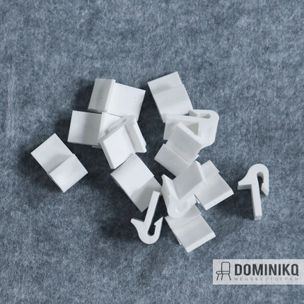 White plastic bank spring clips with spacer on gray background, used for securing bank springs with 20mm nails, available individually.